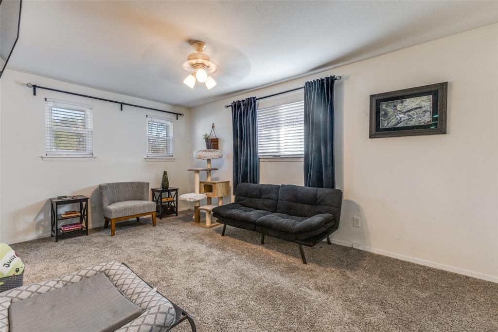 5131 Menefee Drive Dallas, TX 75227 - Photo 16 of 22 a living room with furniture and a potted plant