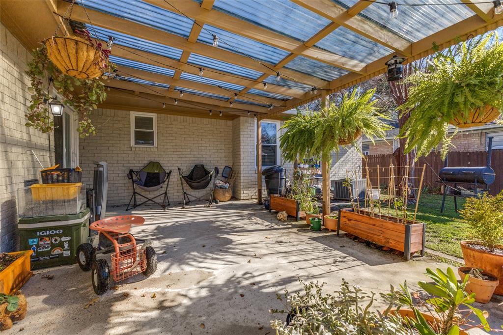5131 Menefee Drive Dallas, TX 75227 - Photo 18 of 22 a backyard of a house with barbeque oven table and chairs