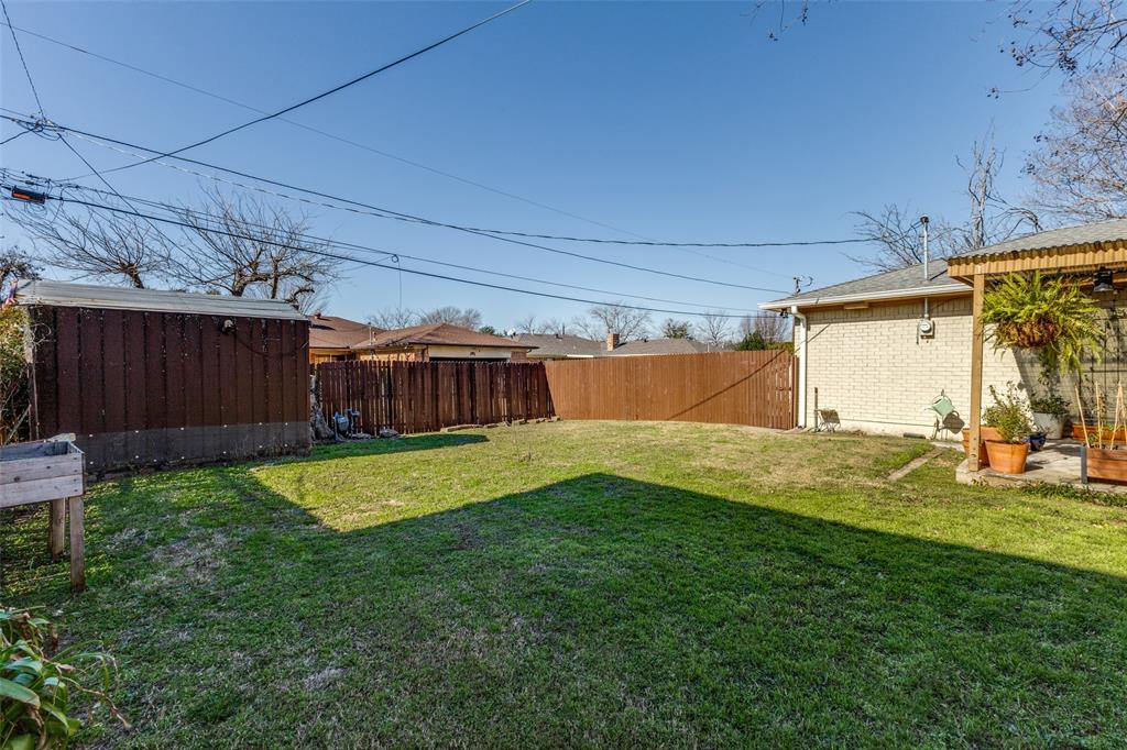 5131 Menefee Drive Dallas, TX 75227 - Photo 20 of 22 a view of a backyard with garage