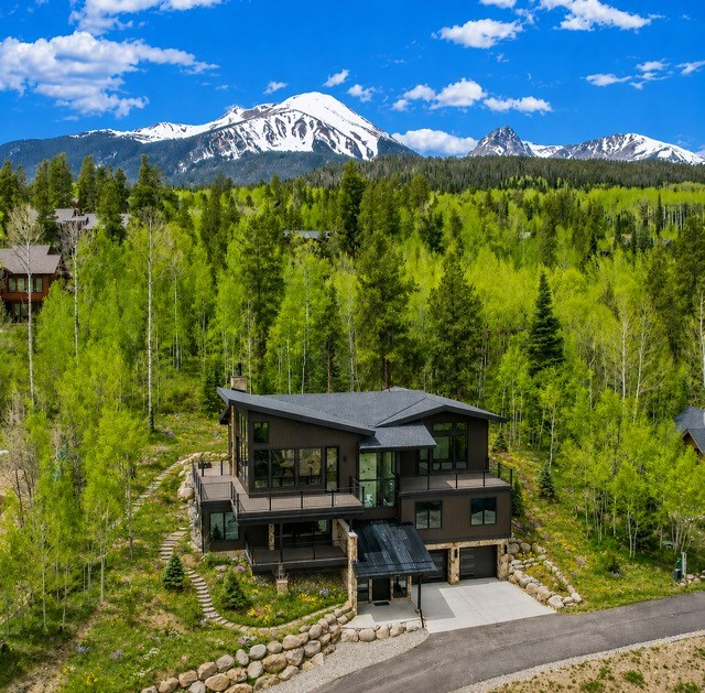 1325 Golden Eagle Road Silverthorne, CO 80498 - Photo 2 of 46 a view of a chairs and table in the patio next to a yard