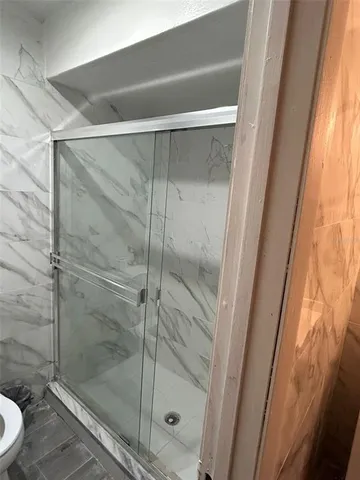 a bathroom with a toilet and a shower