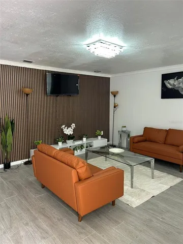 a living room with furniture and a chandelier