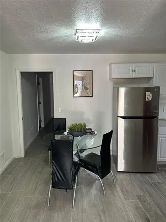a workspace with furniture a chandelier and wooden floor