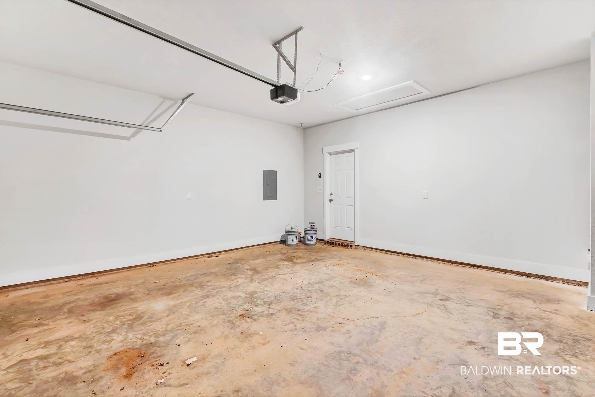 16461 Prado Loop Loxley, AL 36551 - Photo 55 of 78 Garage with electric panel and a garage door opener