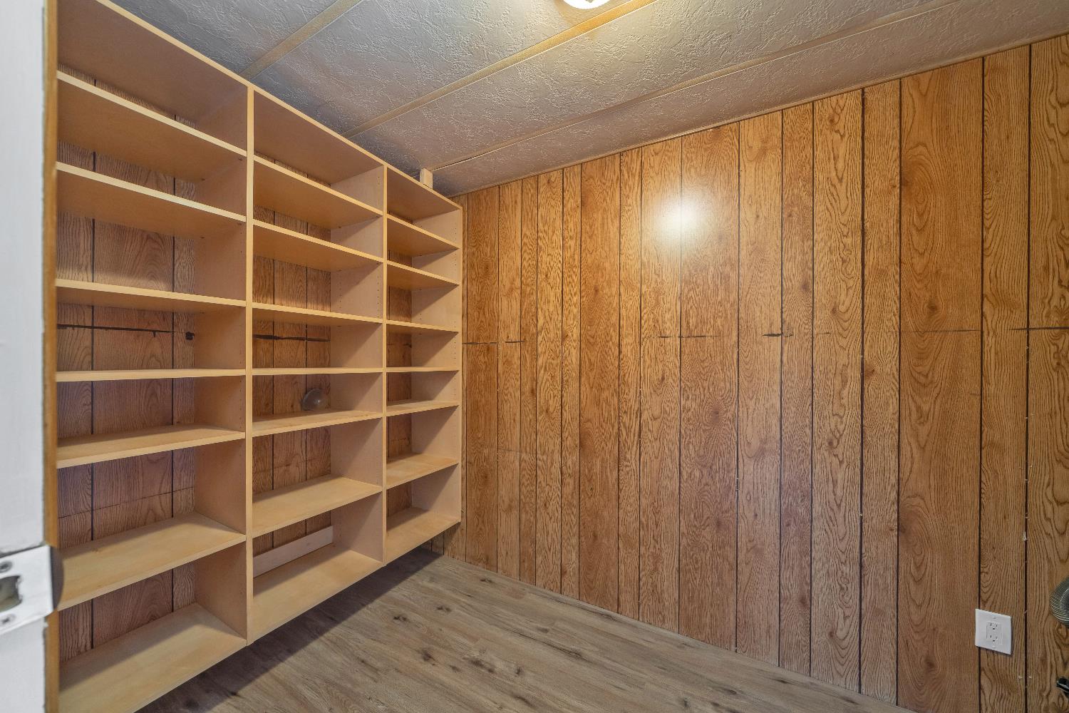 4420 Pleasant Valley Road, Unit 155 Diamond Springs, CA 95619 - Photo 31 of 42 a view of an empty room with wooden shelves
