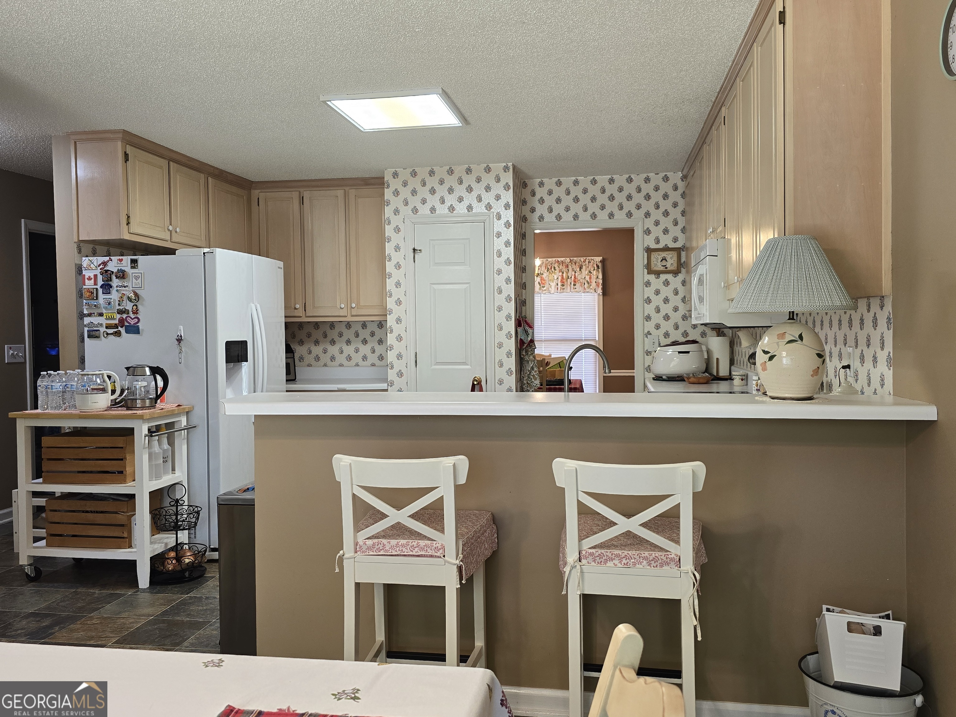 107 Ember Way LaGrange, GA 30240 - Photo 11 of 36 a open kitchen with stainless steel appliances granite countertop a sink and a refrigerator