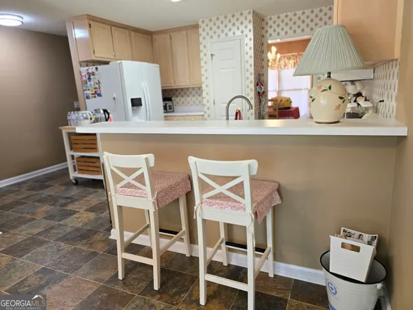 a kitchen with stainless steel appliances a sink and a refrigerator