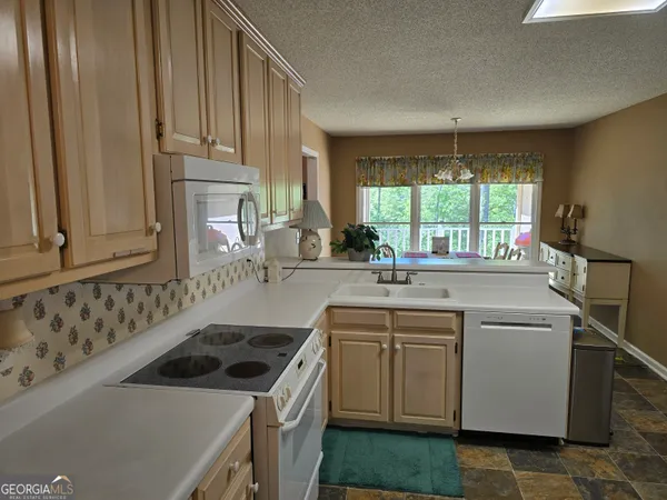 a kitchen with a sink stove and cabinets