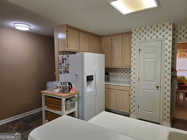 a kitchen with stainless steel appliances a refrigerator and a stove