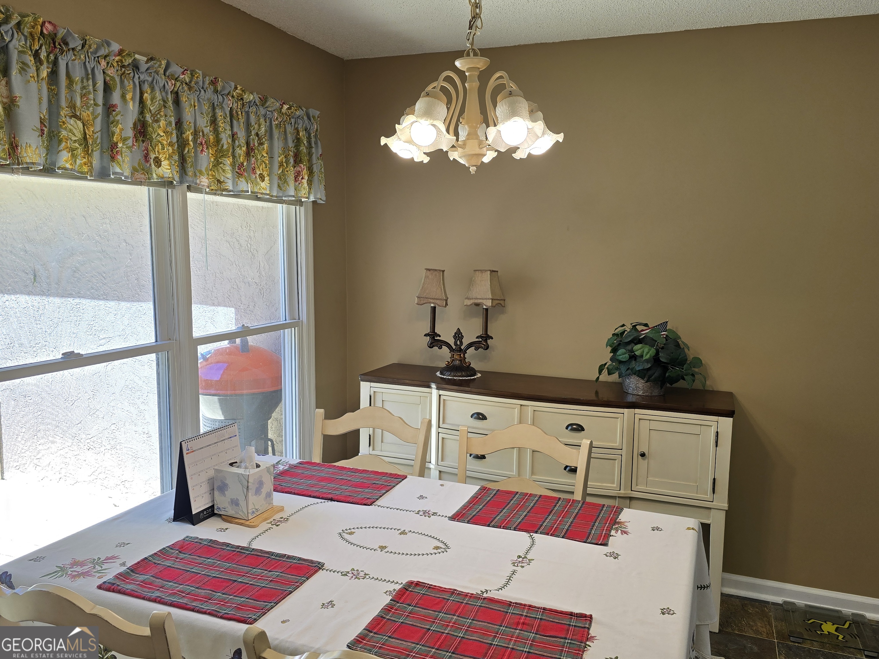 107 Ember Way LaGrange, GA 30240 - Photo 16 of 36 a bedroom with a bed a chandelier and dresser