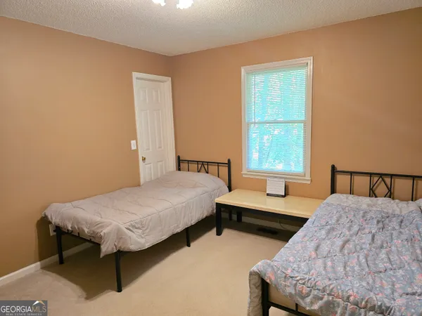 a bedroom with two beds and a window