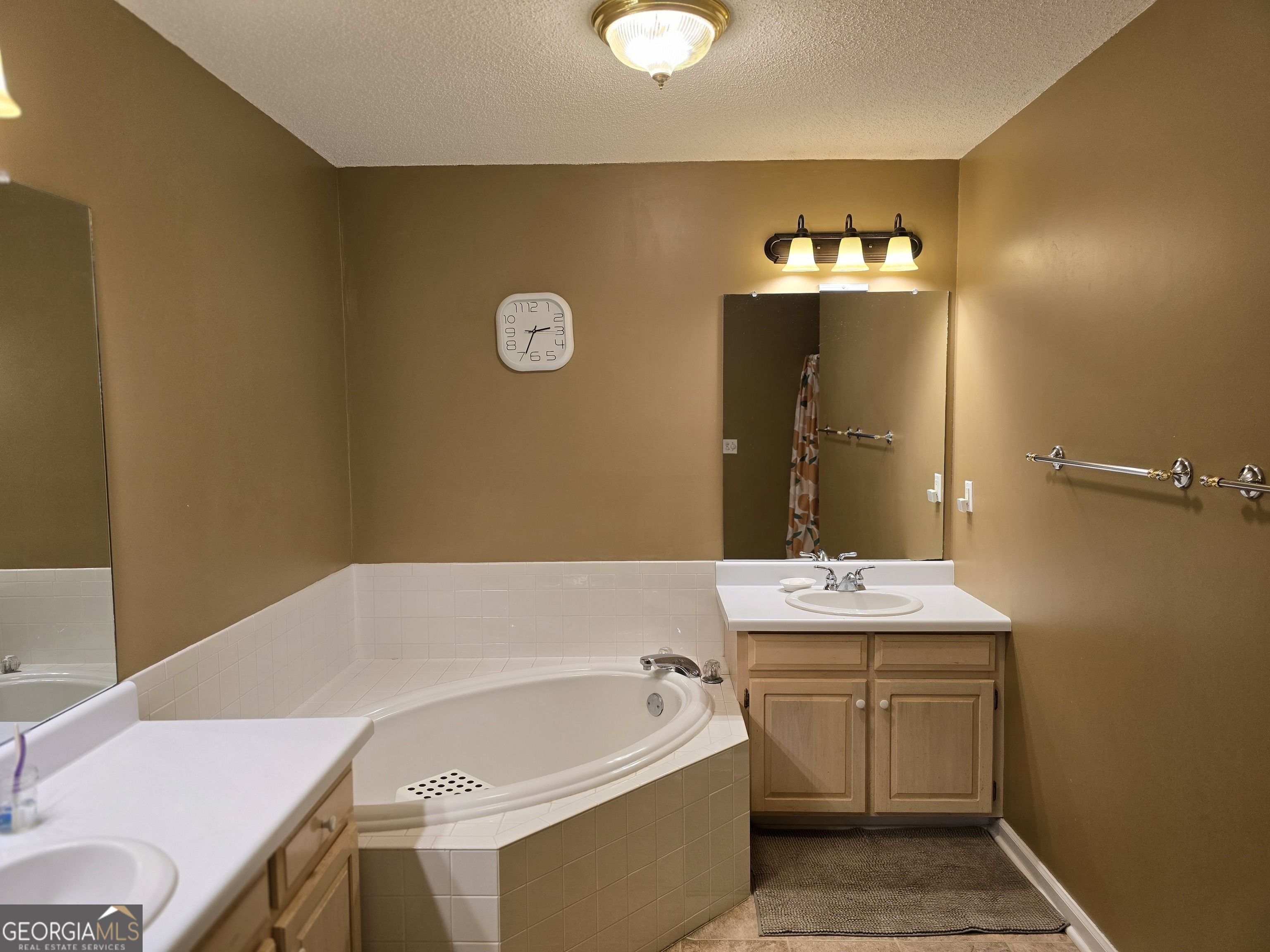107 Ember Way LaGrange, GA 30240 - Photo 28 of 36 a bathroom with a bathtub sink and mirror