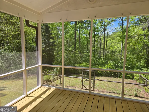 a view of a balcony with floor to ceiling windows with wooden floor