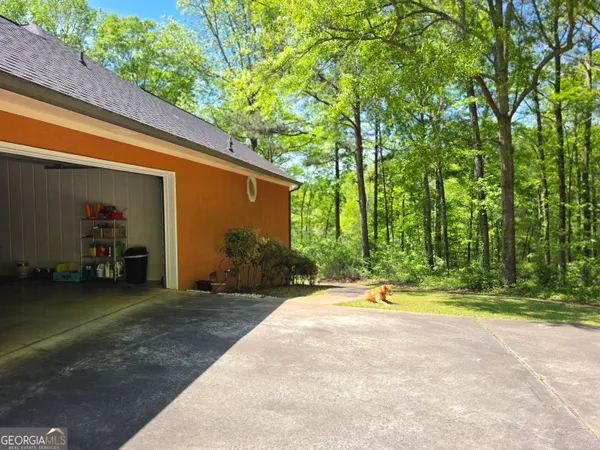 a backyard of a house with barbeque oven table and chairs
