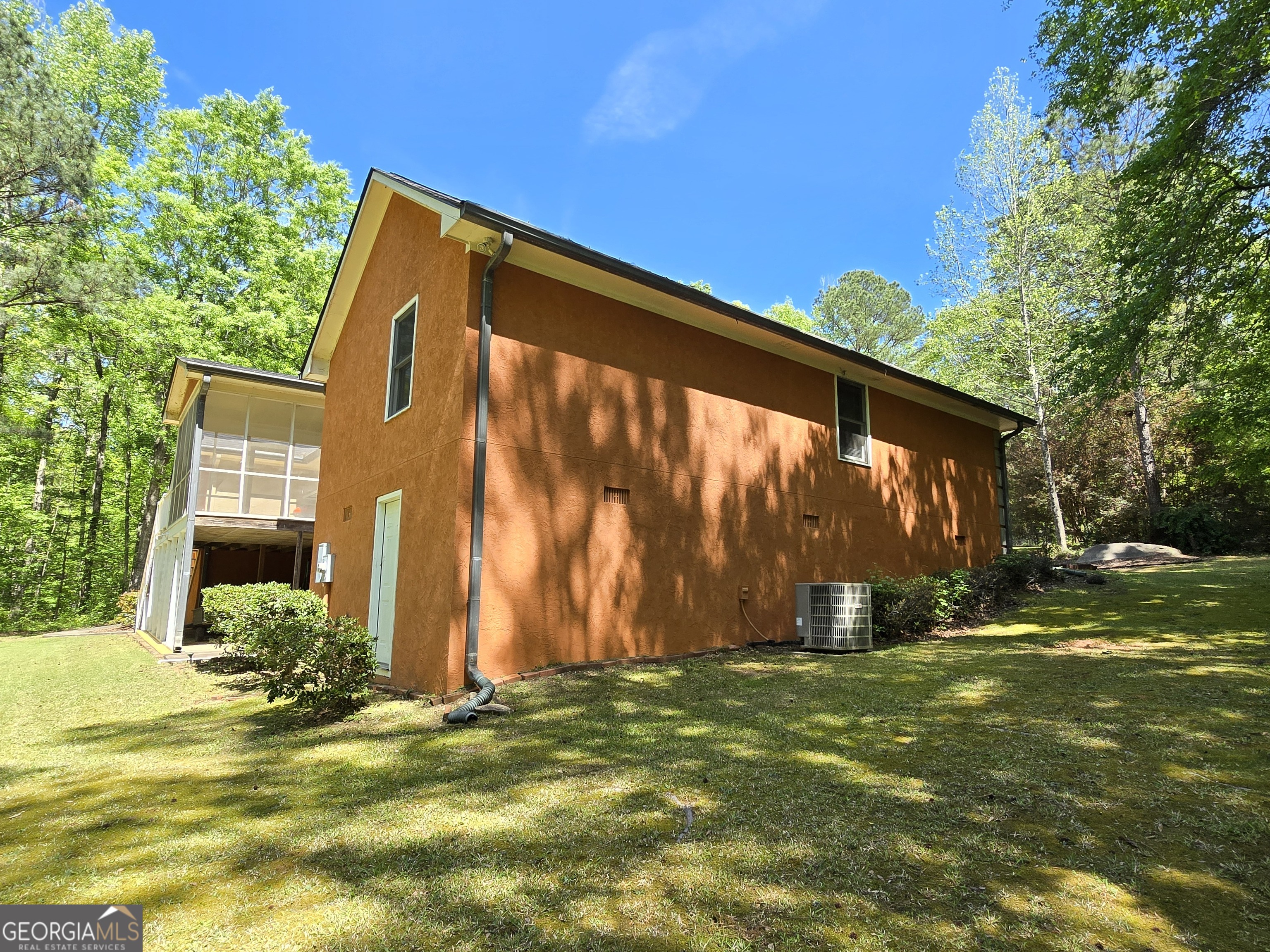 107 Ember Way LaGrange, GA 30240 - Photo 34 of 36 a backyard of a house with plants and large tree