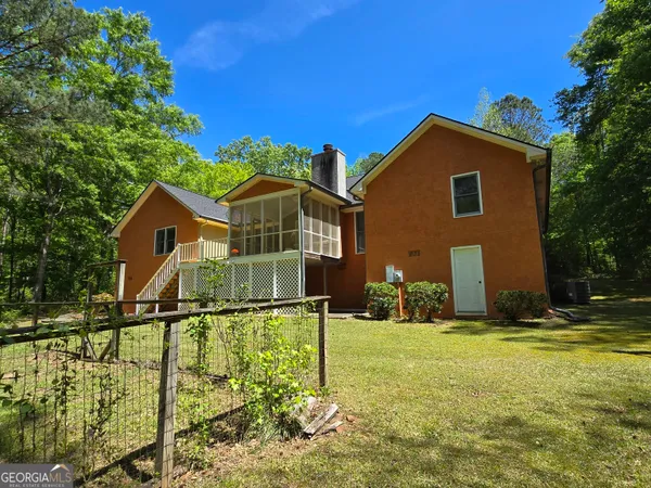 a front view of house with yard and green space