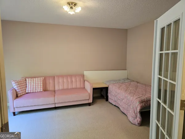 a bedroom with a bed and a couch