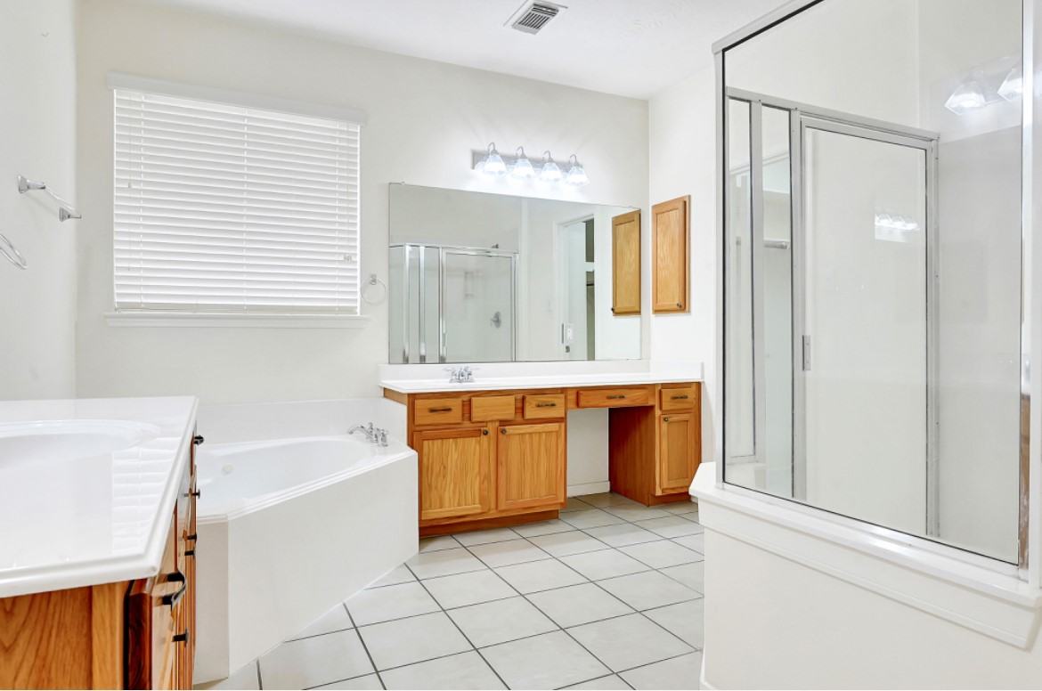 3306 Colleville Sur Mer Lane Spring, TX 77388 - Photo 17 of 40 a bathroom with a tub sink and mirror