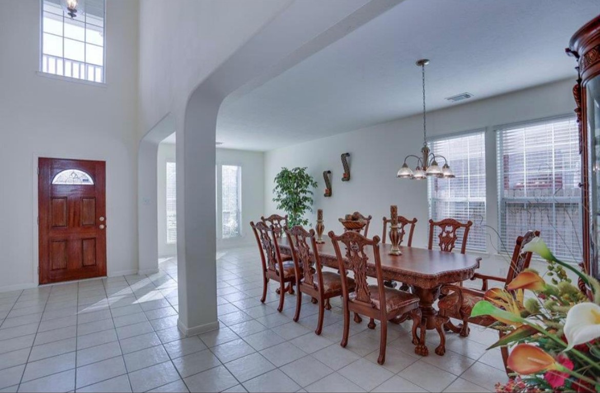 3306 Colleville Sur Mer Lane Spring, TX 77388 - Photo 8 of 40 a view of a dining room with furniture and chandelier