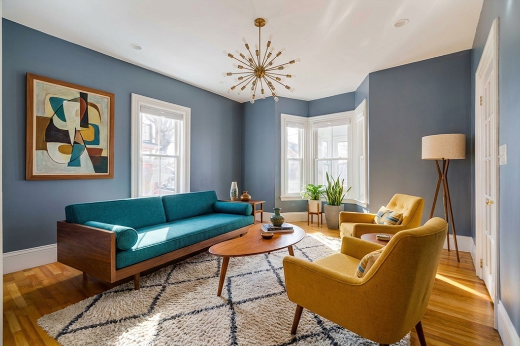21 Berkeley Street Somerville, MA 02143 - Photo 11 of 36 a living room with furniture a chandelier and a window