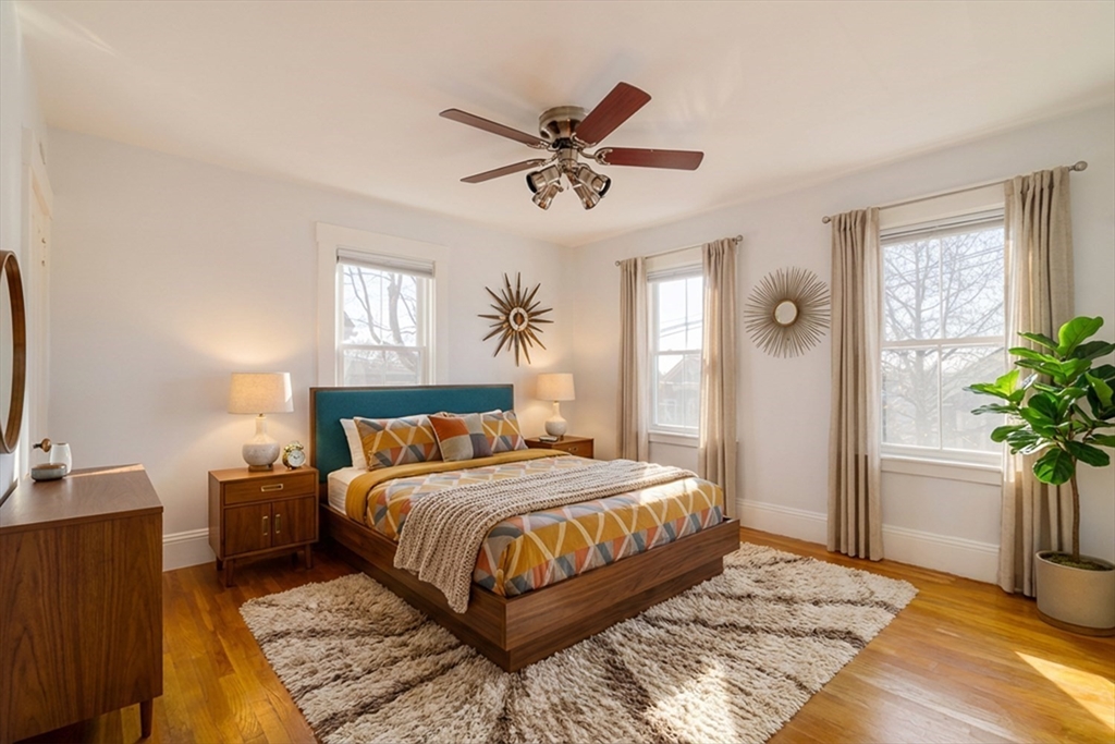 21 Berkeley Street Somerville, MA 02143 - Photo 18 of 36 a bedroom with a large bed and a chandelier