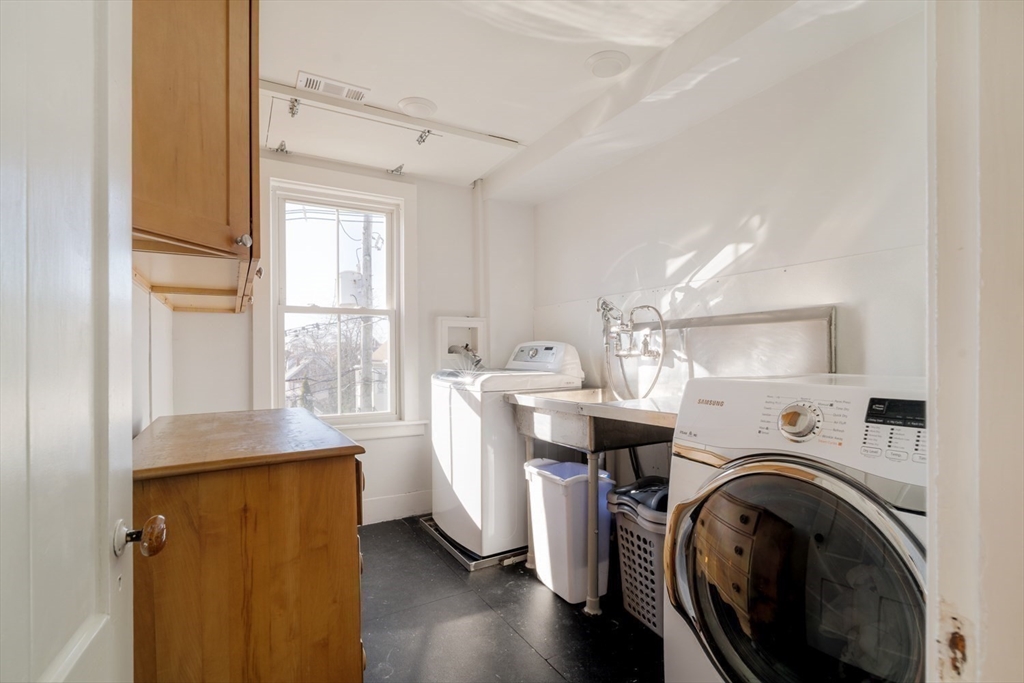 21 Berkeley Street Somerville, MA 02143 - Photo 22 of 36 a view of kitchen with sink a washer and dryer