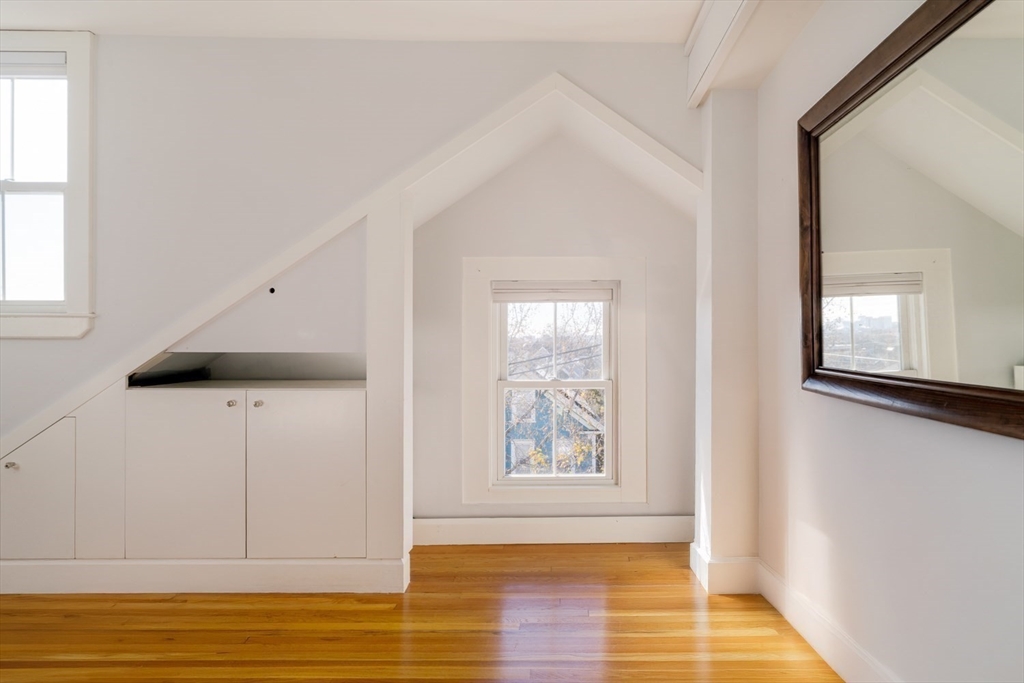 21 Berkeley Street Somerville, MA 02143 - Photo 24 of 36 a view of an empty room with wooden floor and a window