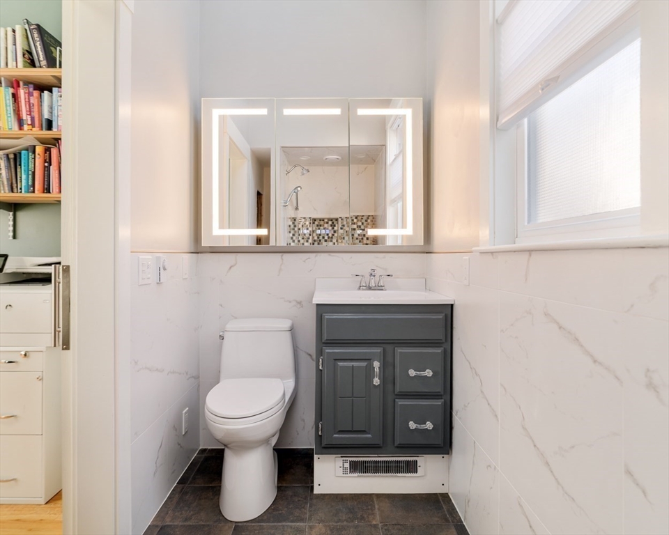 21 Berkeley Street Somerville, MA 02143 - Photo 31 of 36 a bathroom with a toilet a sink and a window