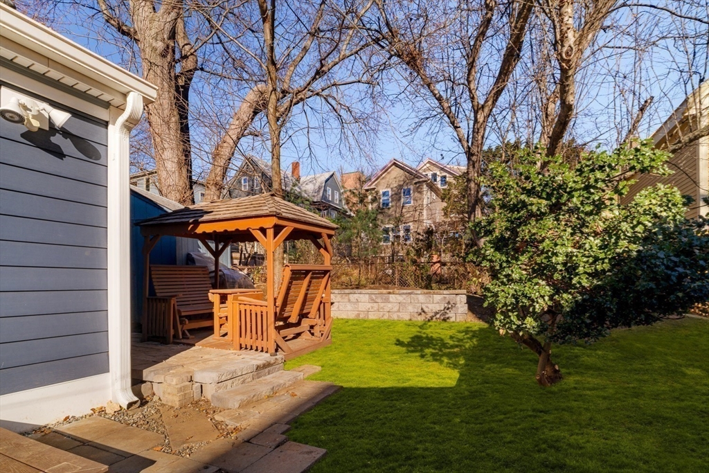 21 Berkeley Street Somerville, MA 02143 - Photo 34 of 36 a view of a patio with table and chairs under an umbrella