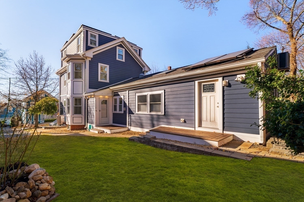21 Berkeley Street Somerville, MA 02143 - Photo 35 of 36 a backyard of a house with wooden floor and outdoor seating