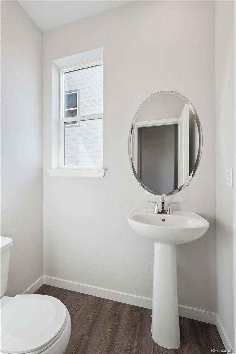 14434 Ranch Street Mead, CO 80504 - Photo 12 of 27 a bathroom with a toilet sink and mirror