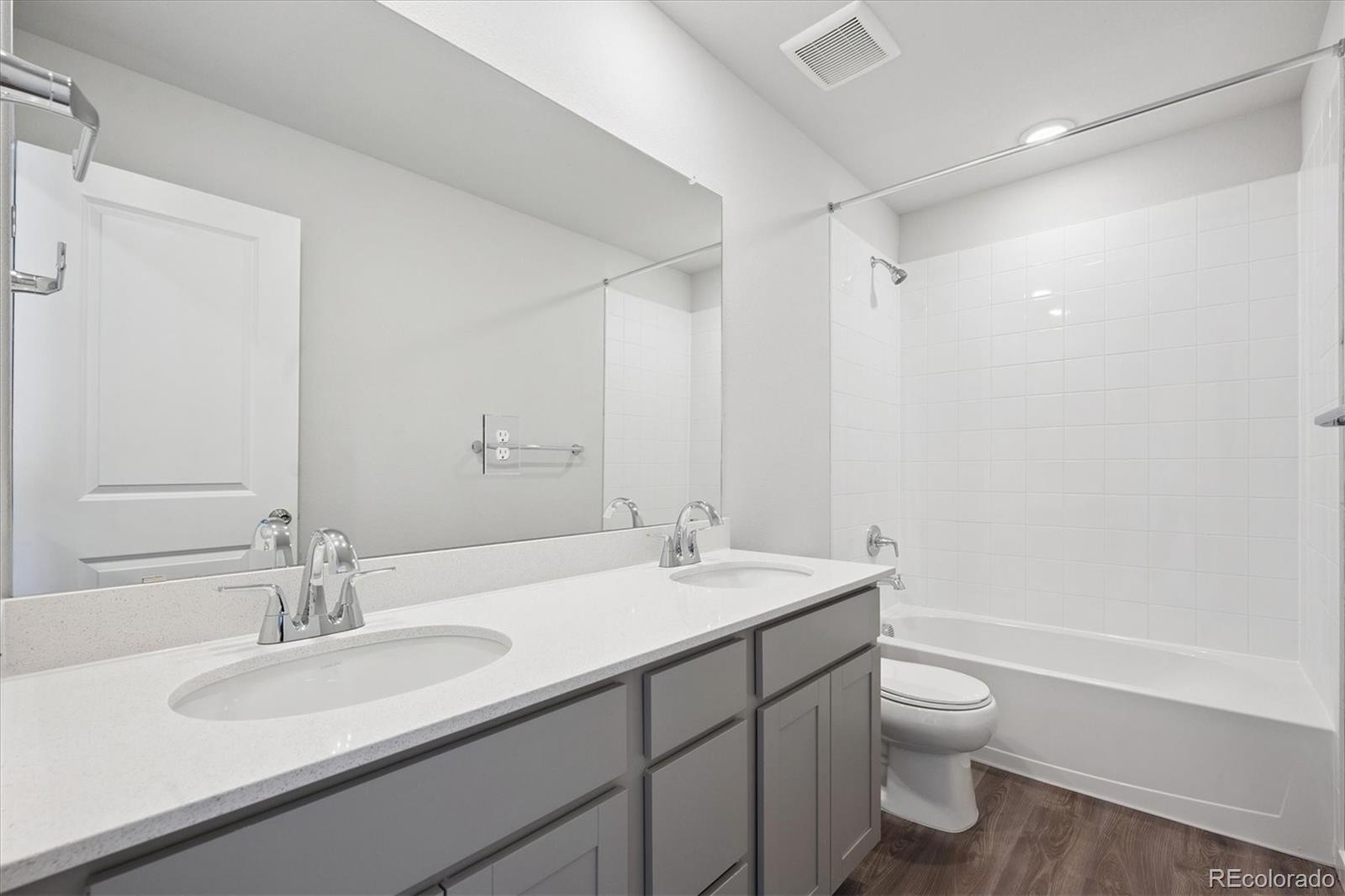 14434 Ranch Street Mead, CO 80504 - Photo 19 of 27 a bathroom with a sink a toilet a tub and a mirror