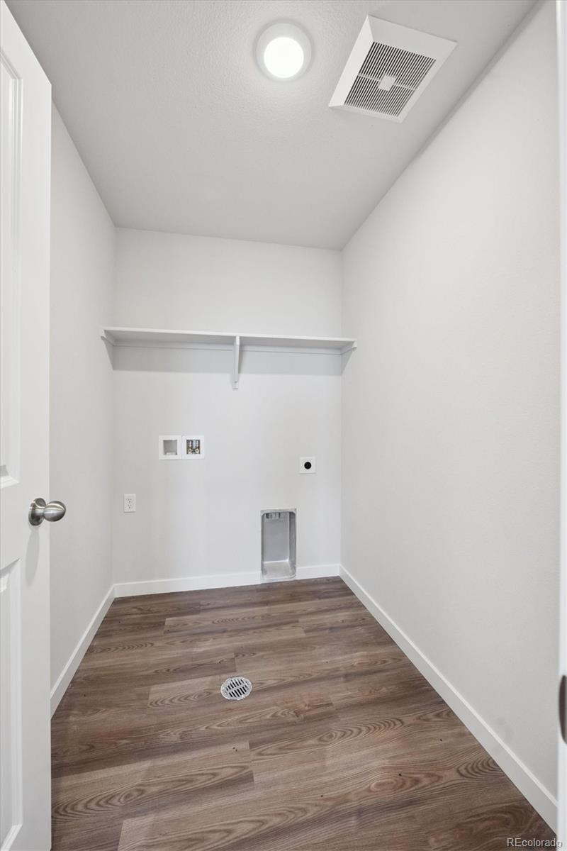 14434 Ranch Street Mead, CO 80504 - Photo 21 of 27 a room with wooden floor and window