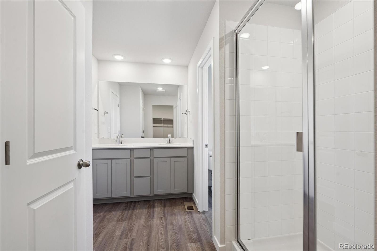 14434 Ranch Street Mead, CO 80504 - Photo 25 of 27 a bathroom with a granite countertop sink mirror and toilet