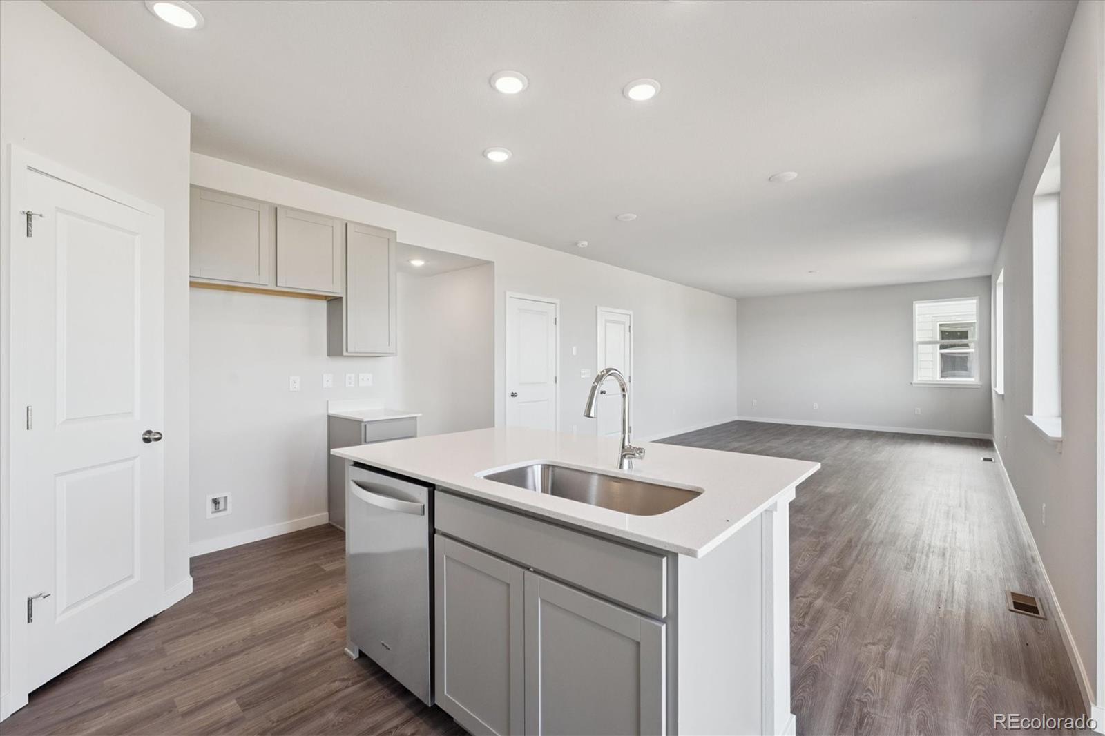 14434 Ranch Street Mead, CO 80504 - Photo 7 of 27 a kitchen with a sink cabinets and wooden floor