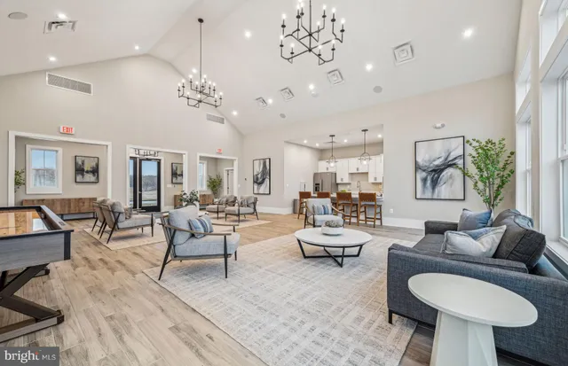 a living room with furniture or couches and a dining table with wooden floor