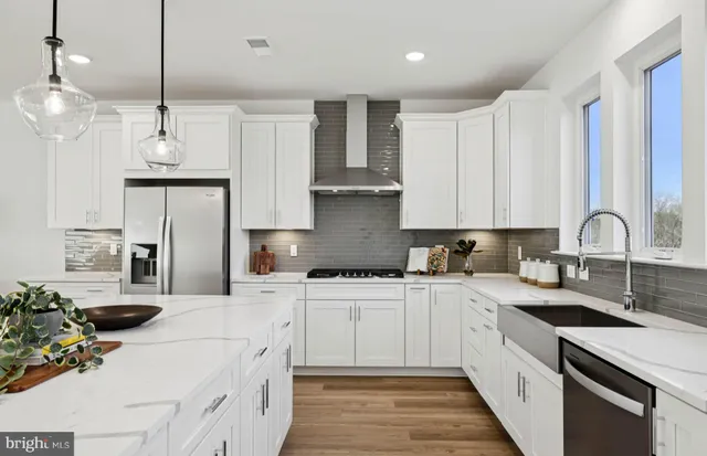 a large kitchen with kitchen island white cabinets and white appliances