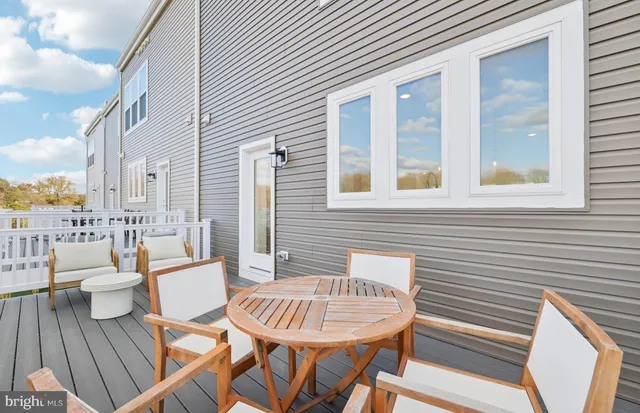 a balcony with wooden floor outdoor seating and city view