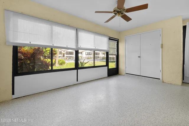 a view of a livingroom with a ceiling fan and window