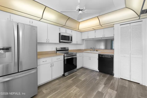 a kitchen with a refrigerator stove and microwave