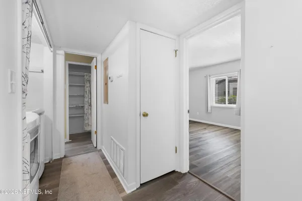 a view of a hallway with a livingroom and a hallway