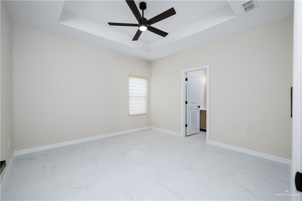 5335 Vision Street Rio Grande City, TX 78582 - Photo 11 of 15 an empty room with windows and fan