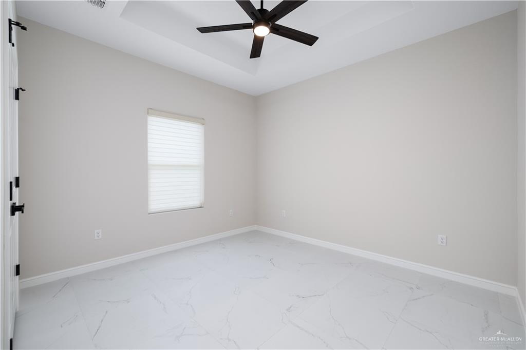 5335 Vision Street Rio Grande City, TX 78582 - Photo 7 of 15 an empty room with a window and a fan