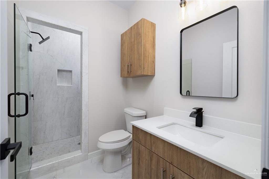 5335 Vision Street Rio Grande City, TX 78582 - Photo 8 of 15 a bathroom with a toilet sink and shower
