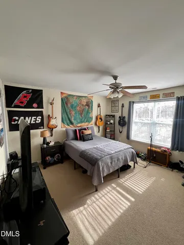 a bedroom with furniture window and a flat screen tv