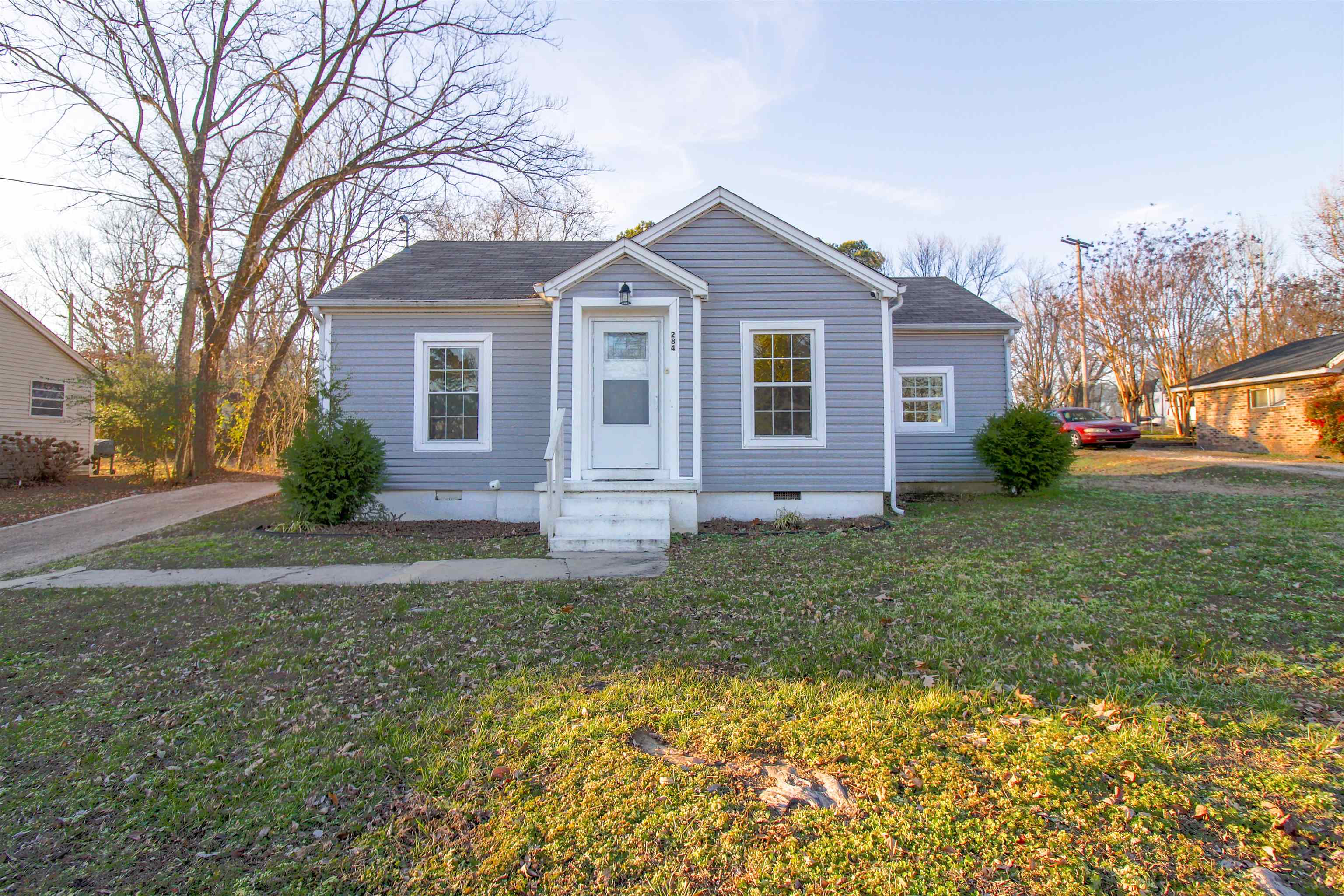 284 Highland Street Ripley, TN 38063 - Photo 1 of 25 a front view of a house with garden