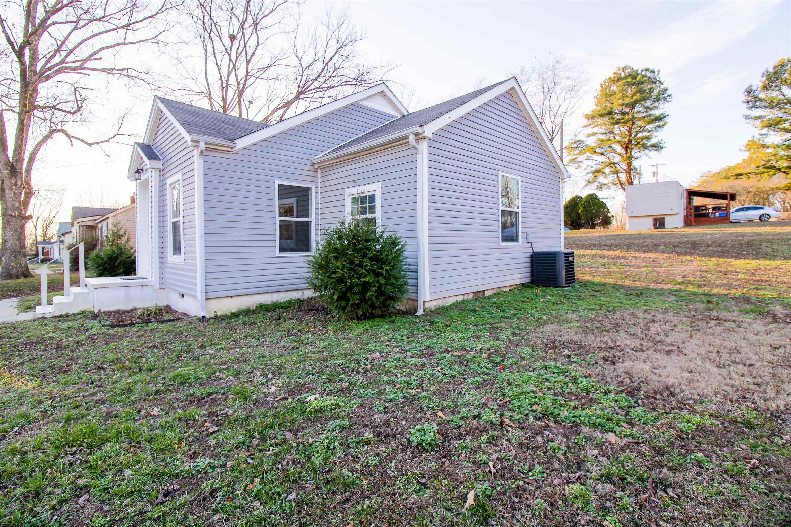 284 Highland Street Ripley, TN 38063 - Photo 20 of 25 a view of a house with a yard and plants