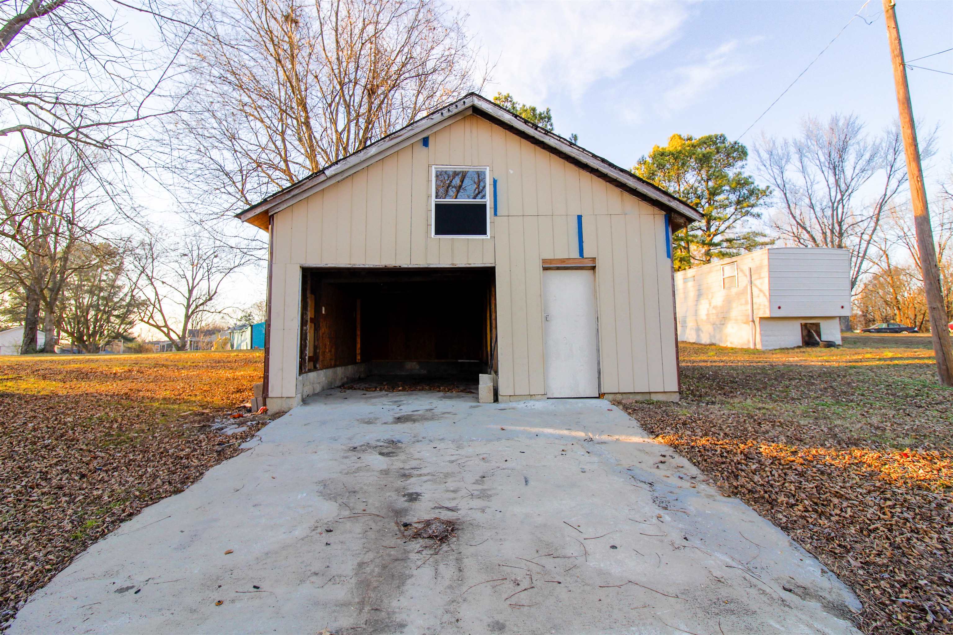 284 Highland Street Ripley, TN 38063 - Photo 23 of 25 a front view of a house with a yard and garage