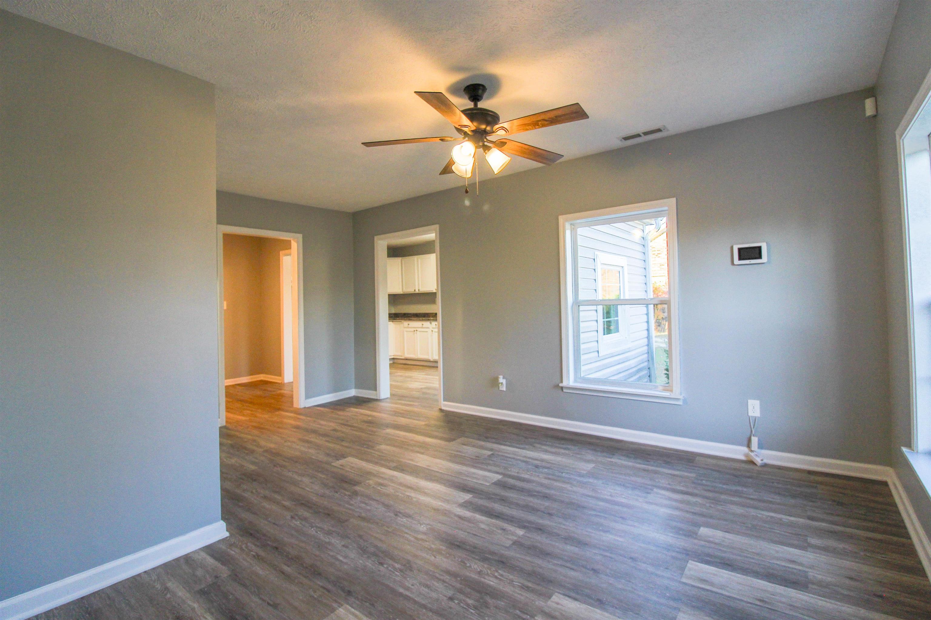 284 Highland Street Ripley, TN 38063 - Photo 4 of 25 a view of an empty room with window and wooden floor