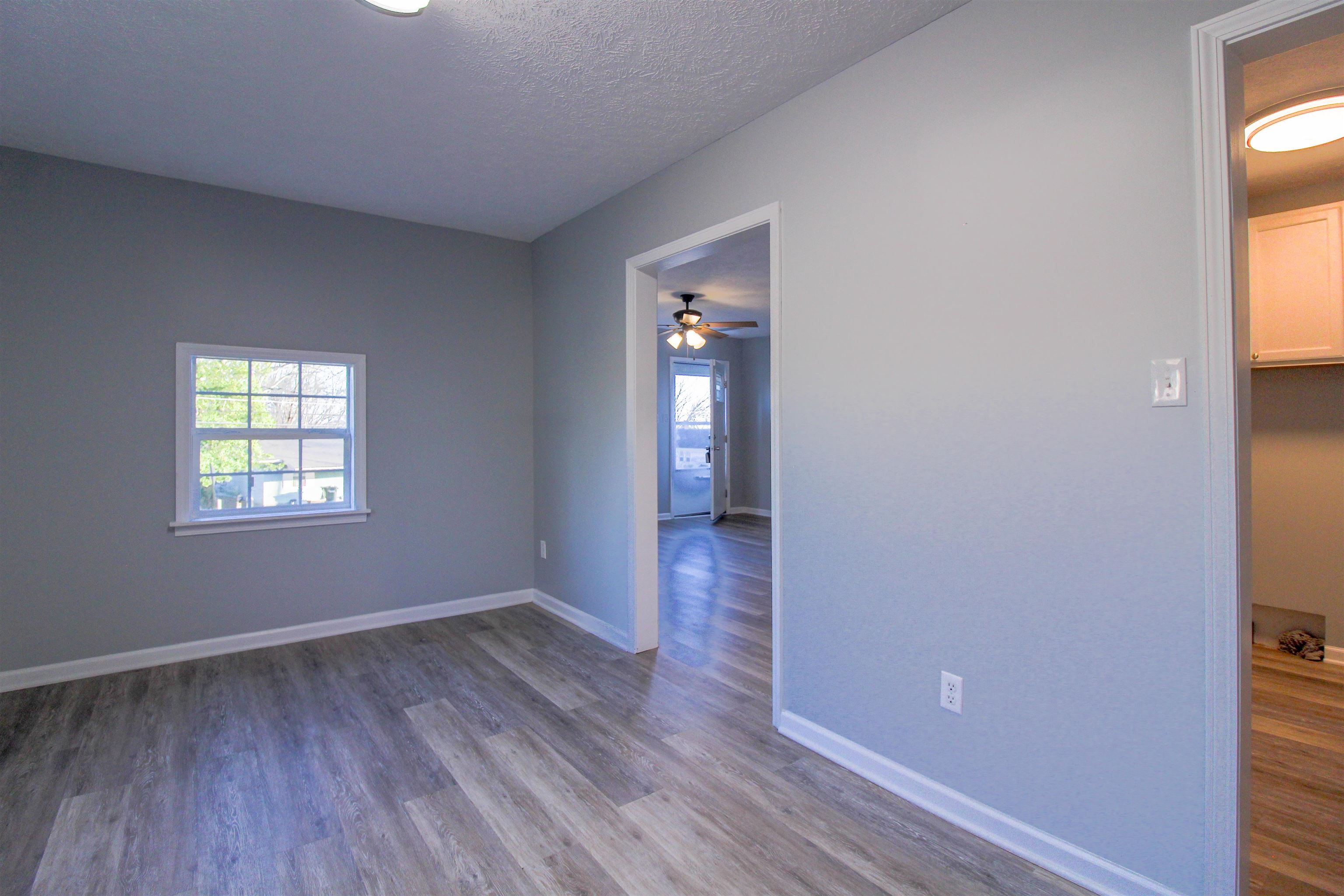 284 Highland Street Ripley, TN 38063 - Photo 7 of 25 an empty room with wooden floor and windows